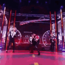 a group of people are dancing on a stage in front of a screen that says ' rpm ' on it
