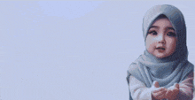 a picture of a baby wearing a hijab with the words terima kasih written above her