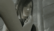 a black and white photo of a girl with a serious look on her face
