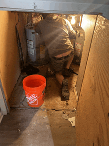 an orange bucket that says home depot sits on the floor