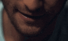 a close up of a man 's mouth with a beard and mustache .