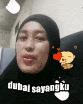 a woman wearing a hijab says duhai sayangku in a cartoon