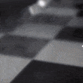 a black and white checkered floor with a arrow pointing to the right