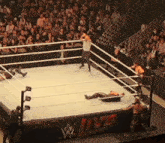 wrestlers in a wrestling ring with a w live sign