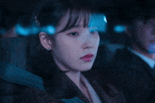 a woman with red lips is sitting in a car
