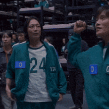 a woman wearing a shirt with the number 24 on the front