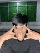 a man is making a funny face with his tongue out .