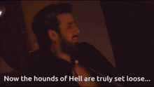 a man with a beard says " now the hounds of hell are truly set loose " in front of candles