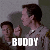 a man in a los angeles sheriff 's uniform has the word buddy on his shirt
