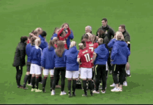 a group of female soccer players are huddled together and one of them has the number 11 on her jersey