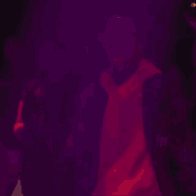 a blurry picture of a person in a purple light
