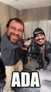 a man wearing a blizzard hat is standing next to another man with a beard