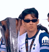 a man holding a trophy that says final 2025