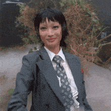 a woman in a suit and tie with a horseshoe pattern