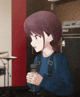 a girl holding a microphone in front of an amplifier that says fender