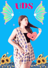 a woman holding a heart with uds written on the top