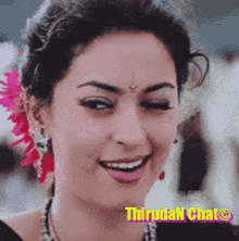 a close up of a woman 's face with a flower in her hair and the words thrudan chat written on the bottom
