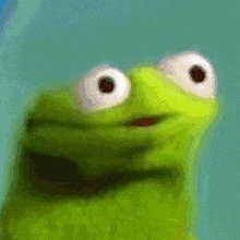 a green frog with big white eyes making a surprised face