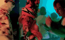 a pixelated image of a man talking to another man in a dark room