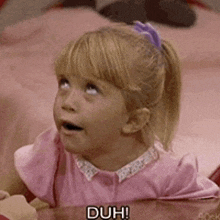 a little girl in a pink dress says duh while looking up