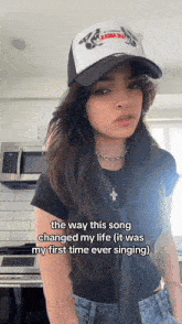 a woman wearing a hat that says the way this song changed my life it was my first time ever singing