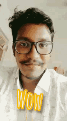 a man with glasses and a mustache is wearing a shirt that says wow .