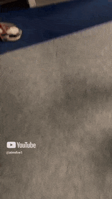 a screenshot of a video on youtube shows a person walking down a hallway