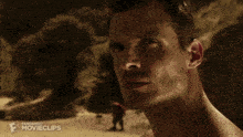 a movie clip of a man breaking a rock