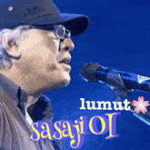a man singing into a microphone with the word sasajioi on the bottom right