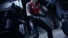 a woman in a red wig is kneeling down in a dark room