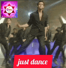 a man is dancing in front of a sign that says " just dance "