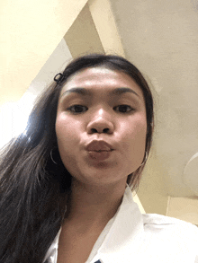 a woman making a funny face with her lips closed
