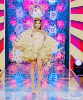 a woman is walking down a runway wearing a costume that looks like a bird .