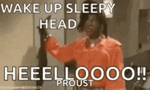 a man in a red shirt is holding a black object in his hand and says `` wake up sleepy head ! ''