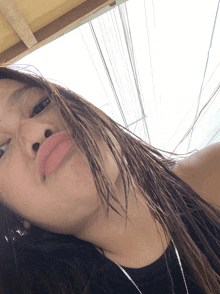 a close up of a woman 's face with a few telephone wires in the background