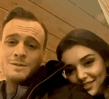 a man and a woman are posing for a picture together .