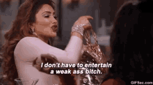 a woman is holding a purse and saying `` i don t have to entertain a weak ass bitch '' .