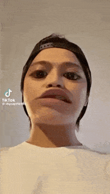 a close up of a person 's face with a hat on .