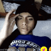 a man wearing a blue shirt that says asds on it