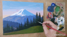 a painting of a mountain and trees is being painted on a canvas