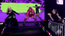 a group of people are dancing on a stage in front of a crowd and a sign that says a & s
