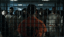 a man in a jail cell with the number 10c on his shirt