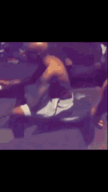 a man is doing exercises on a treadmill in a gym .