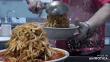 a person is pouring noodles into a bowl with a ladle and the words made in animotica on the bottom