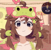 a girl wearing a frog headband with a frog on her head