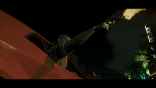 a man in a car is holding a gun in his right hand