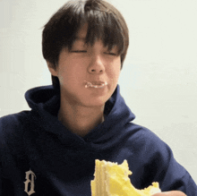 a boy in a blue hoodie with the letter d on it