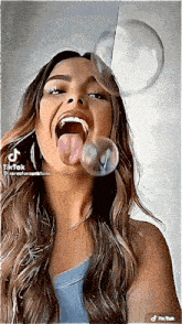 a woman blowing bubbles with her tongue out and a tiktok watermark