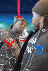 two men are standing next to each other with one wearing a jacket that says ' raspberry ' on it