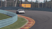 a white race car is going around a curve